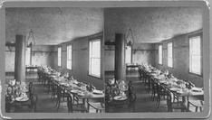 SA0441 - Tables set for dining. Associated with the South Family. Identified on the back. Stereo card contains an ad for other views in the series that this is a part of., Winterthur Shaker Photograph and Post Card Collection 1851 to 1921c